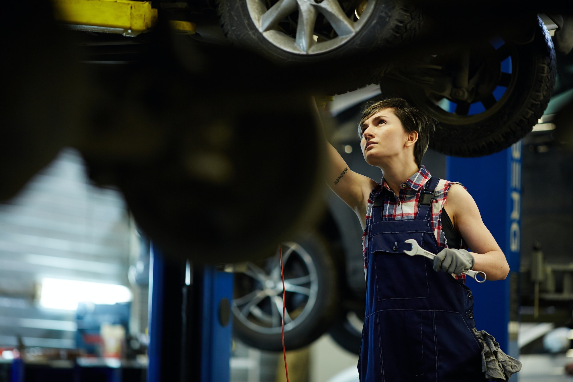 Woman repairing car