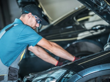 Worker Repairing Car