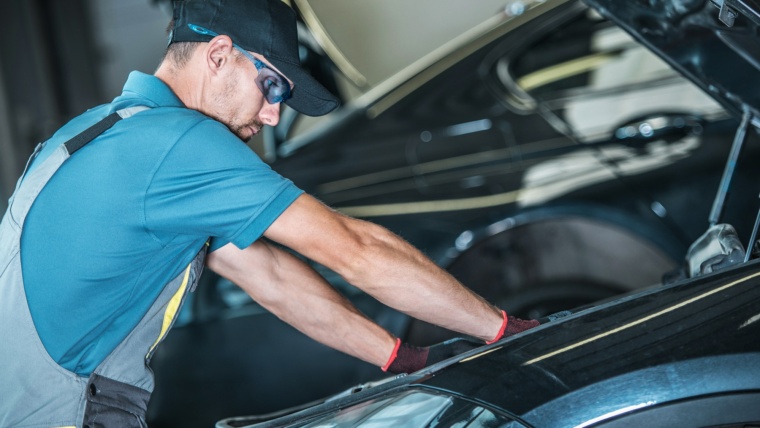 Worker Repairing Car