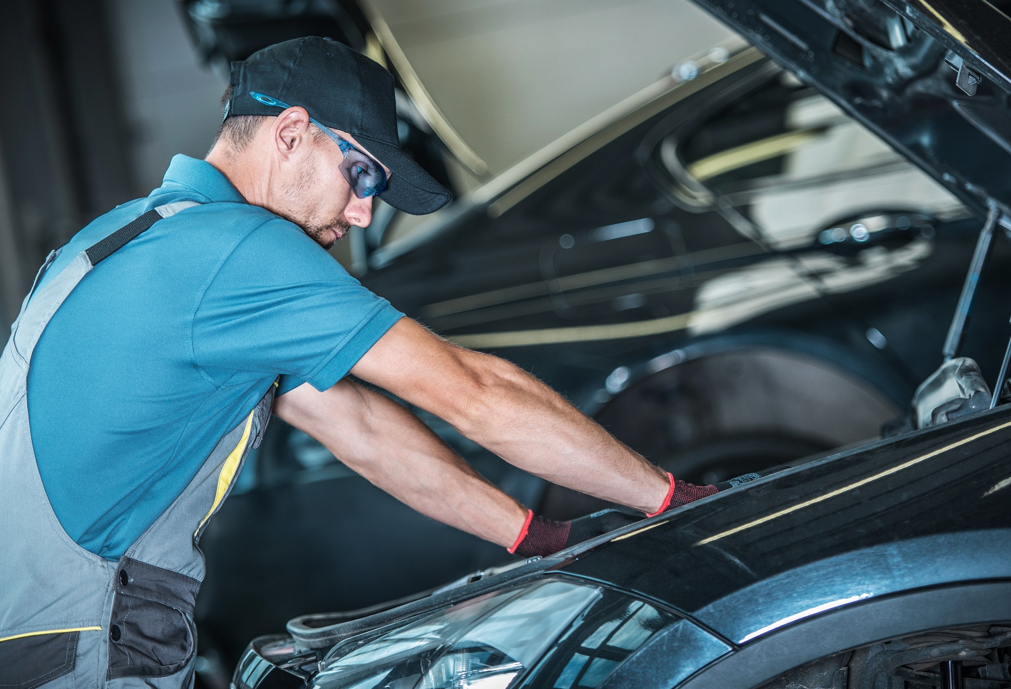 Worker Repairing Car